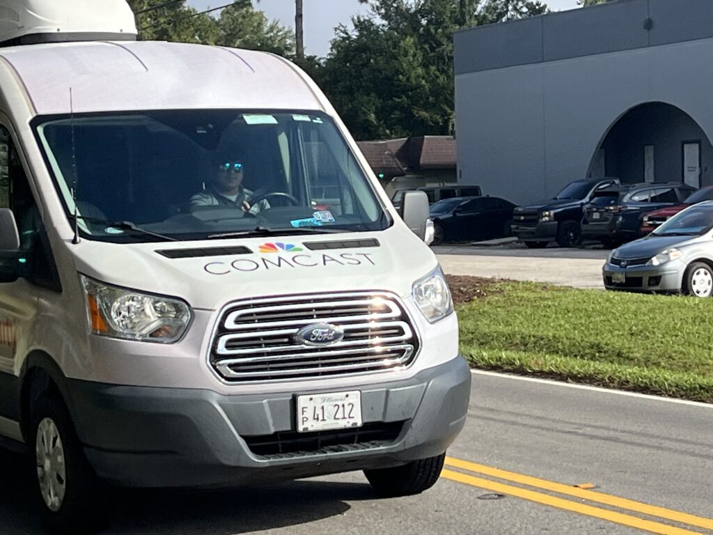 Comcast employee driving Xfinity WiFi van 
