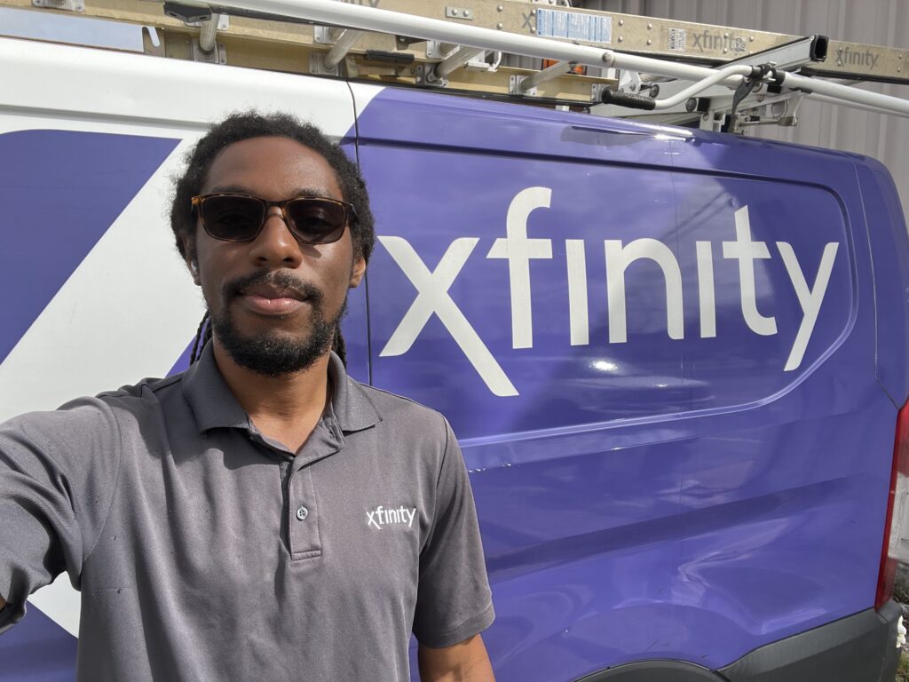 Comcast tech posing with his truck
