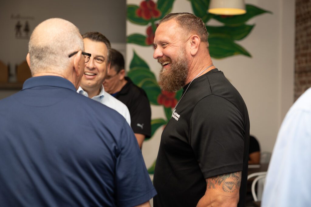 Social Grounds Coffee Roasters owner Jason Kelloway with Chef Robert Irvine and Senior Vice President of Comcast Florida, Jeff Buzzelli.