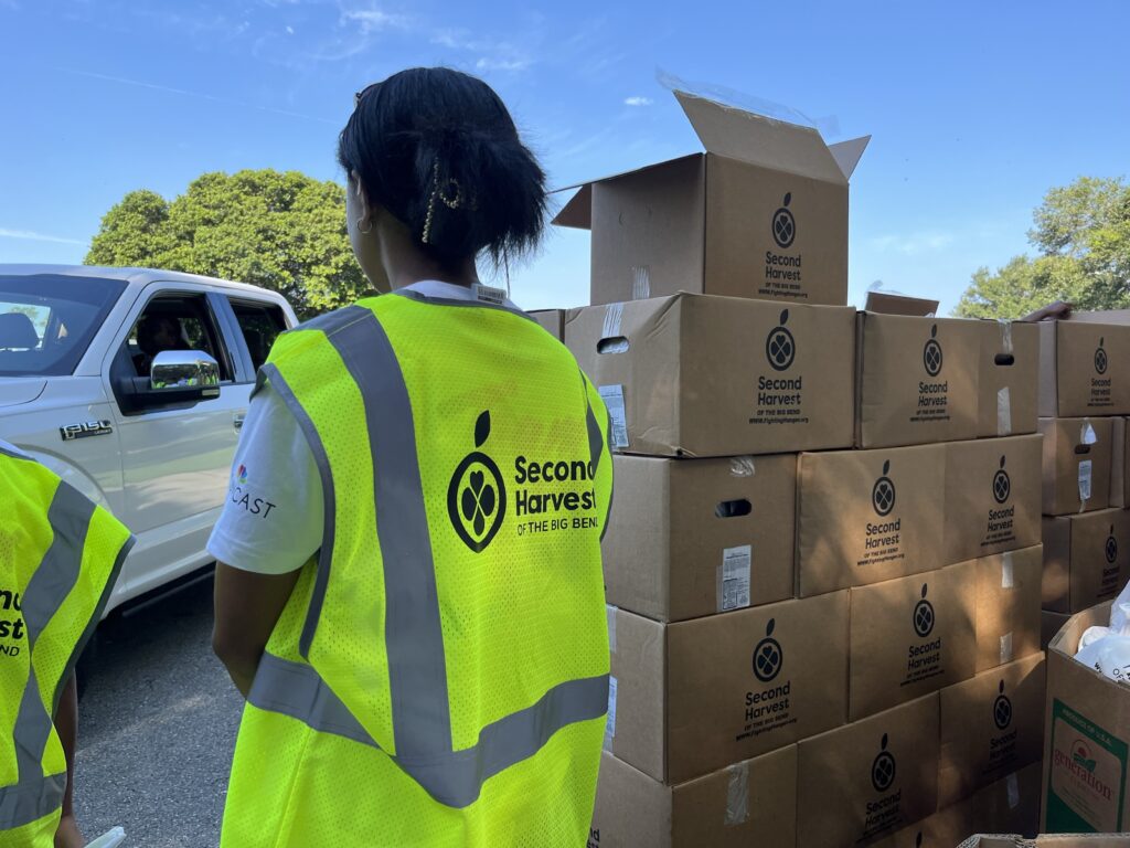 Comcast volunteer handing out boxes
