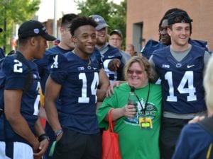 football players with a woman