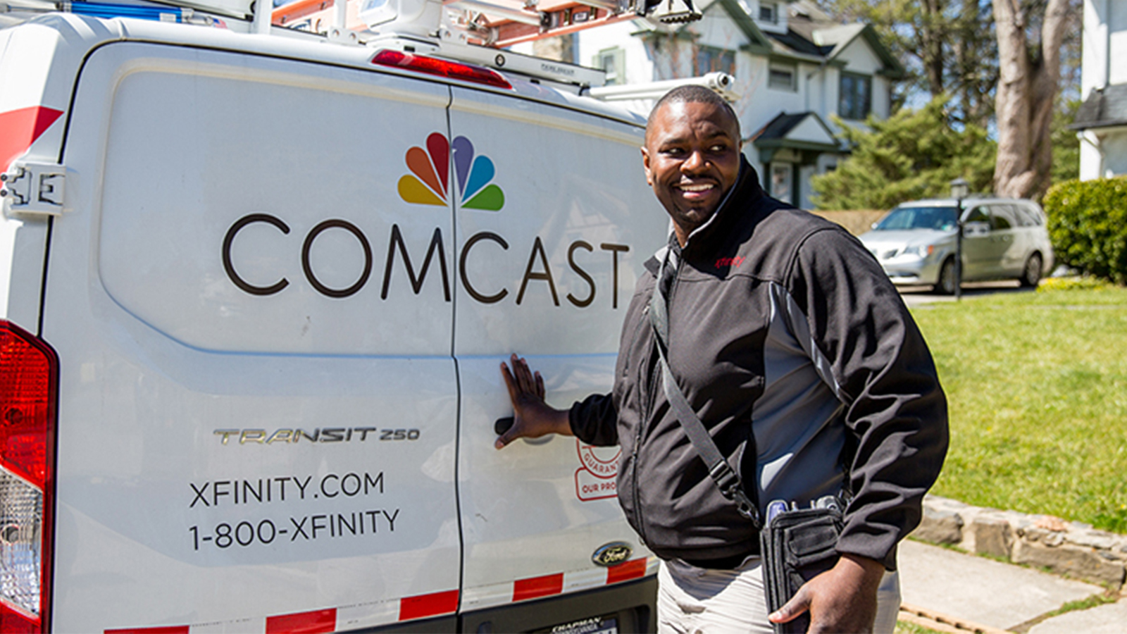 Comcast technician at the back of his truck.