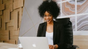 woman typing on her laptop