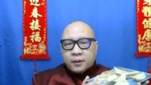 Man holding a plate of dumplings