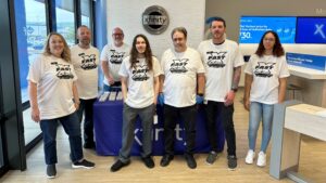 Group of employees wearing matching t-shirts inside York Xfinity Store