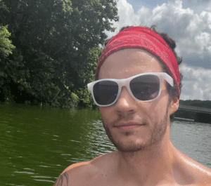 Man in sunglasses near river