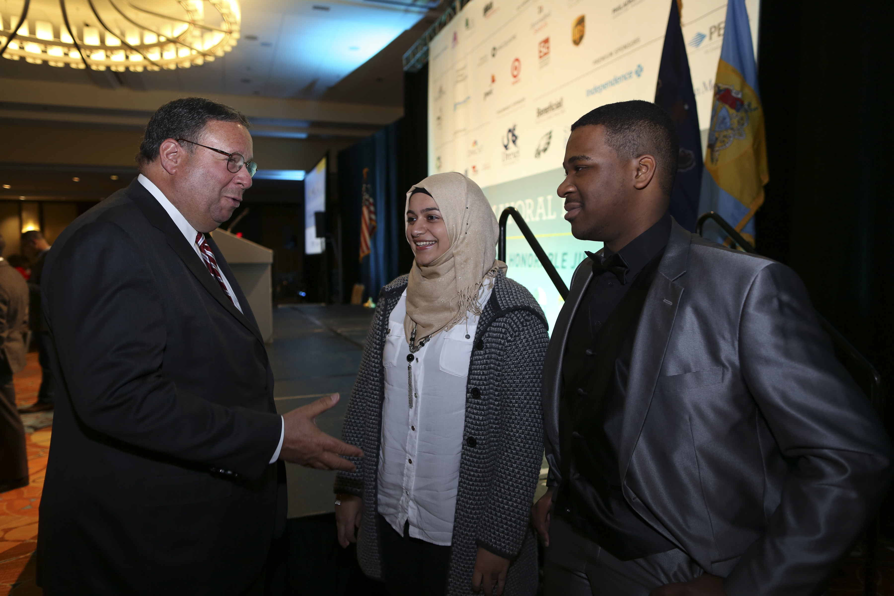 David L. Cohen, Senior Executive Vice President & Chief Diversity Officer poses with the Gustave G. Amsterdam Leadership Award recipients Fakira Awawdeh and Widchard Faustin on Thursday Feb. 2, 2017, during the Chamber of Commerce for Greater Philadelphia's Annual Mayor's Luncheon in Philadelphia. (Comcast Photo/ Joseph Kaczmarek)