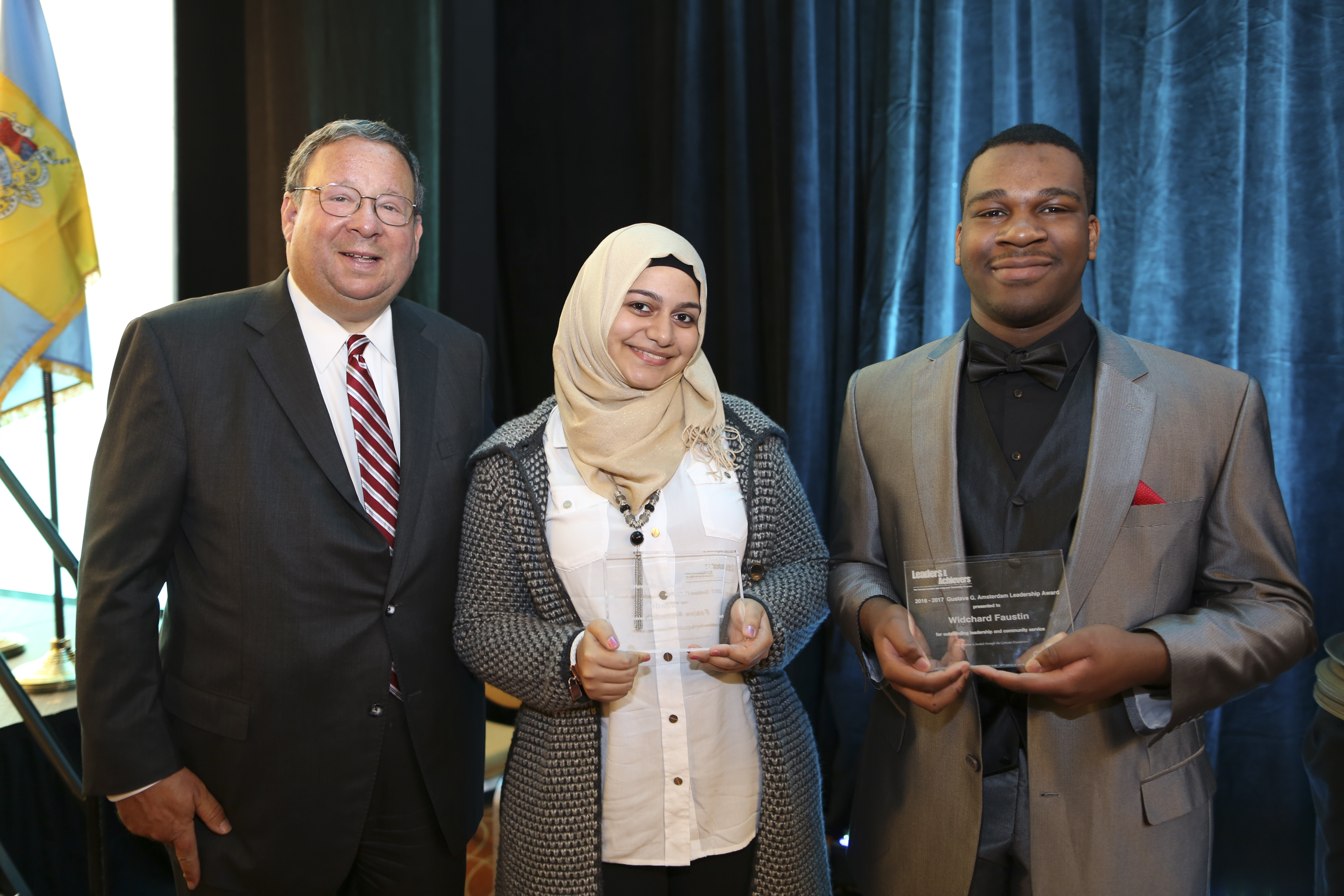 David L. Cohen, Senior Executive Vice President & Chief Diversity Officer poses with the Gustave G. Amsterdam Leadership Award recipients Fakira Awawdeh and Widchard Faustin on Thursday Feb. 2, 2017, during the Chamber of Commerce for Greater Philadelphia's Annual Mayor's Luncheon in Philadelphia.  (Comcast Photo/ Joseph Kaczmarek)