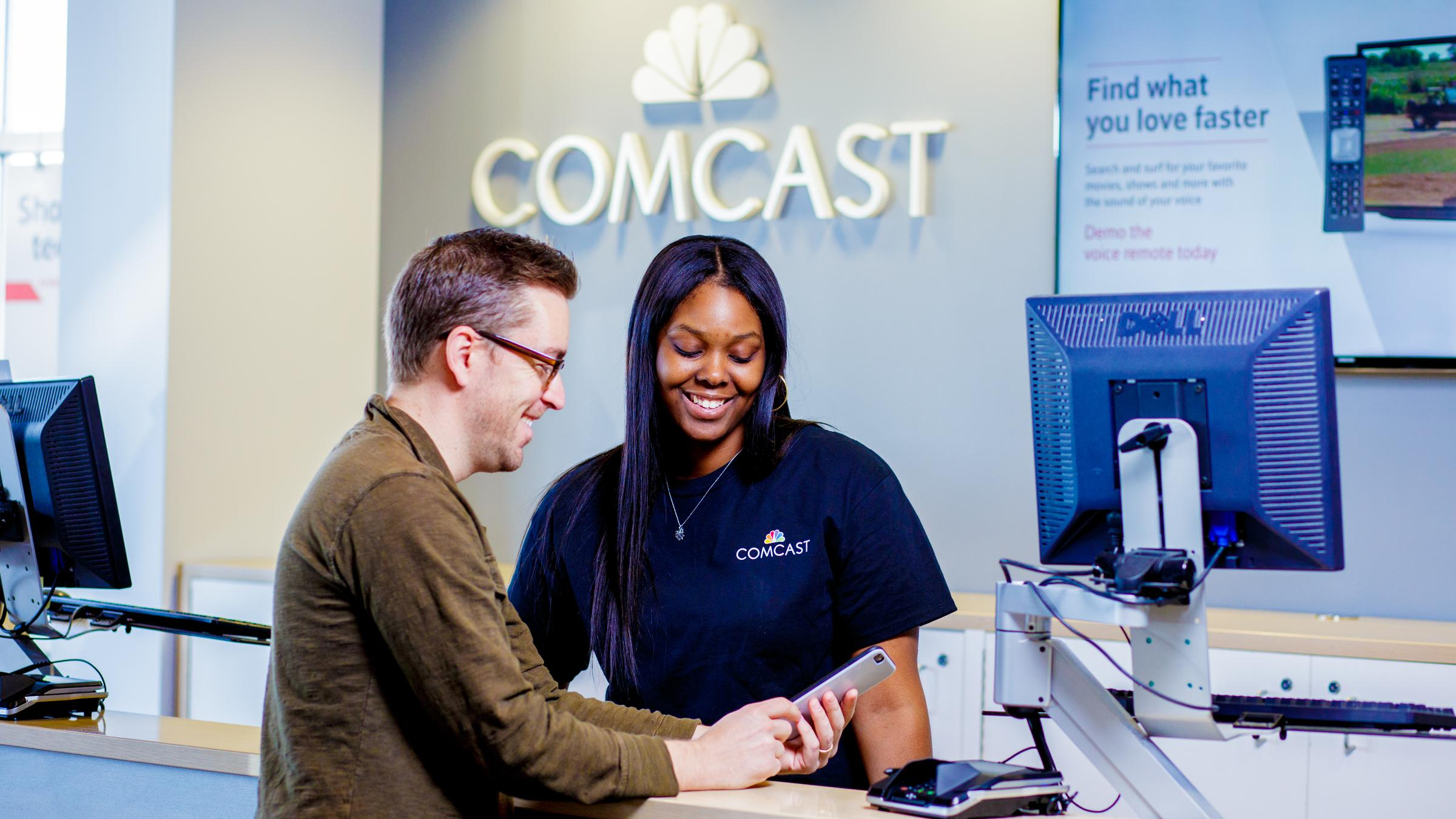 An Xfinity Store team member assists a customer