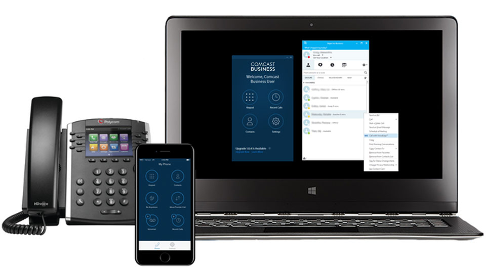 A desk phone, mobile phone, and laptop display the Comcast Business app.