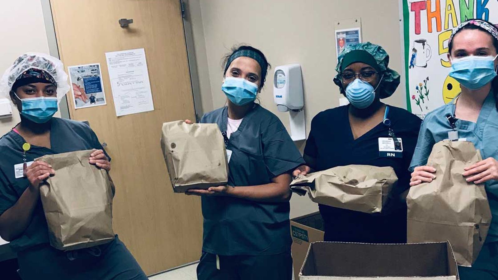 Hospital employees holding a bag.