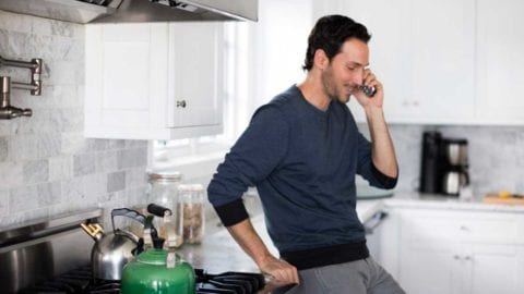 Man on phone in kitchen
