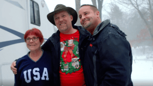 Xfinity customers and an Xfinity technician smiling.