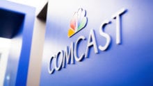 The Comcast logo on a wall.