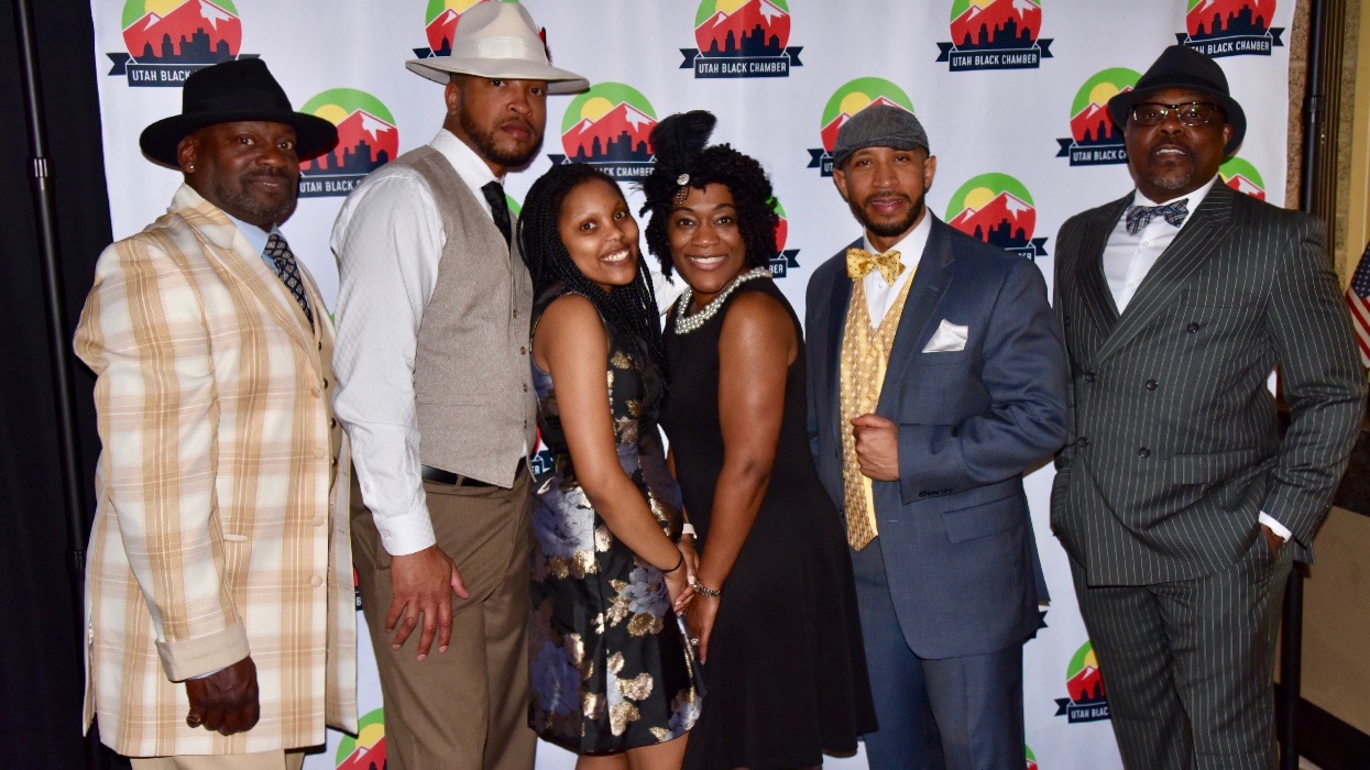 Members of The Utah Black Chamber pose for a photo-op at an event.