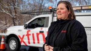 Michelle Hathenbruck stands in front of her Xfinity service van.