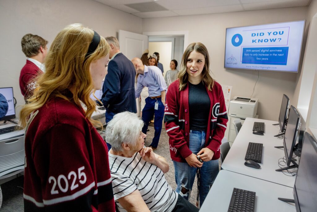 Students Tess Sellick, left, and Carly Andrews talk with Sandra Ring in the new Comcast Digital Literacy Center at the Eagle Mountain Chamber of Commerce during a ribbon cutting event on Thurs., April 25, 2024 in Eagle Mountain, Utah.