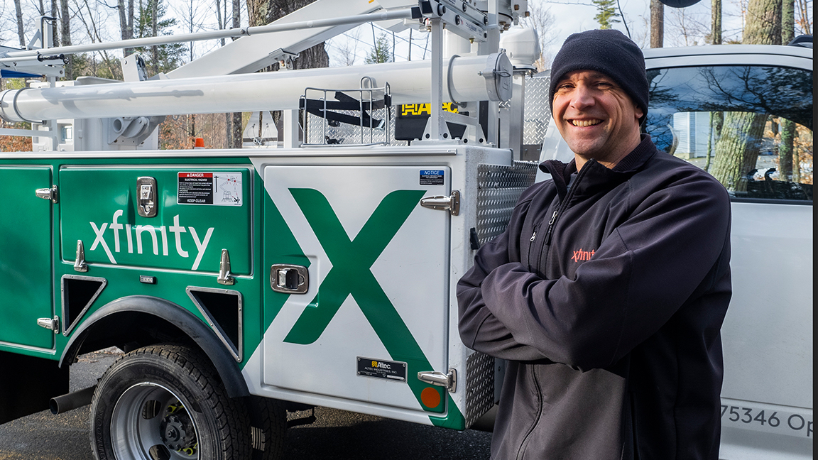Technician Tony smiling and standing next to Xfinity truck.