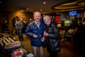 couple standing inside movie theater lobby