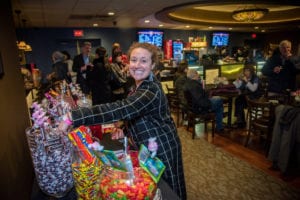 women filling bag with candy from vintage candy bar