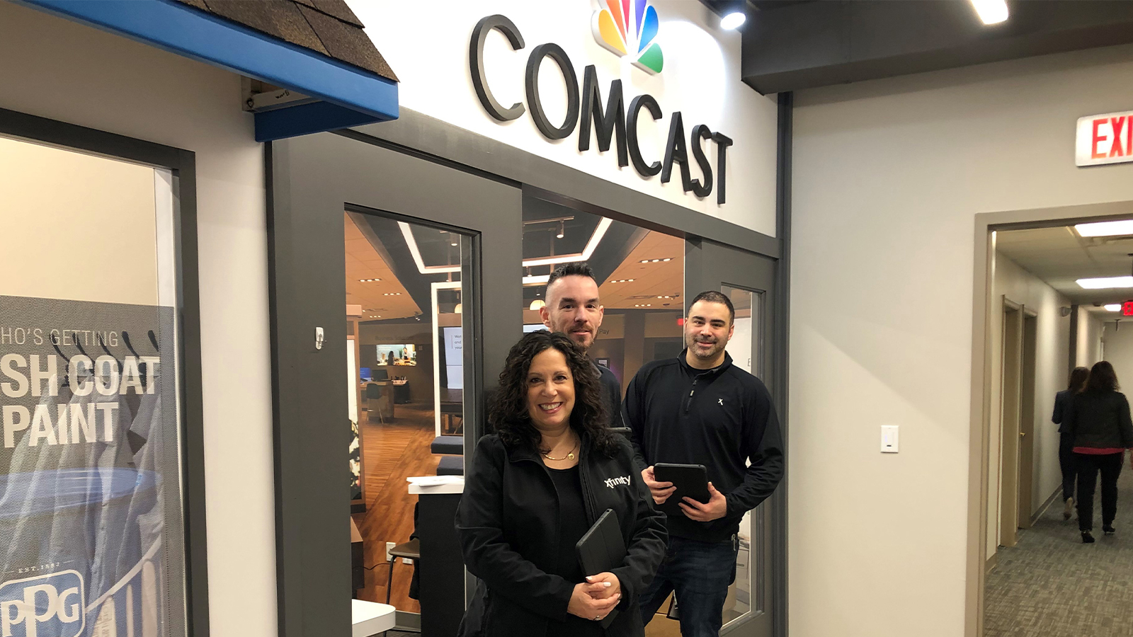 Comcast employees in front of store in BizTown
