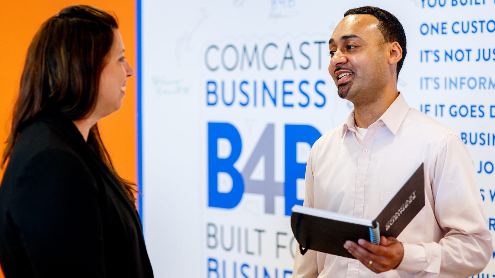 Comcast Business employee talking to business owner.
