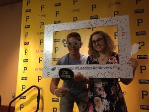two students taking photo in selfie frame