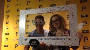 two students taking photo in selfie frame