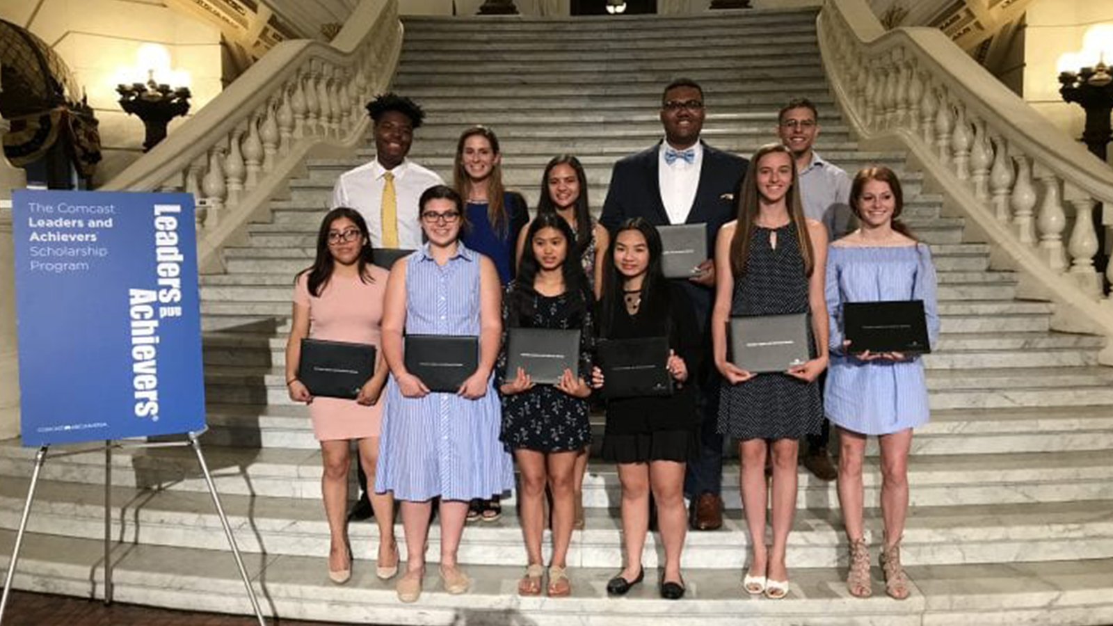 Students who won Comcast scholarships standing on steps in Pennsylvania Capitol