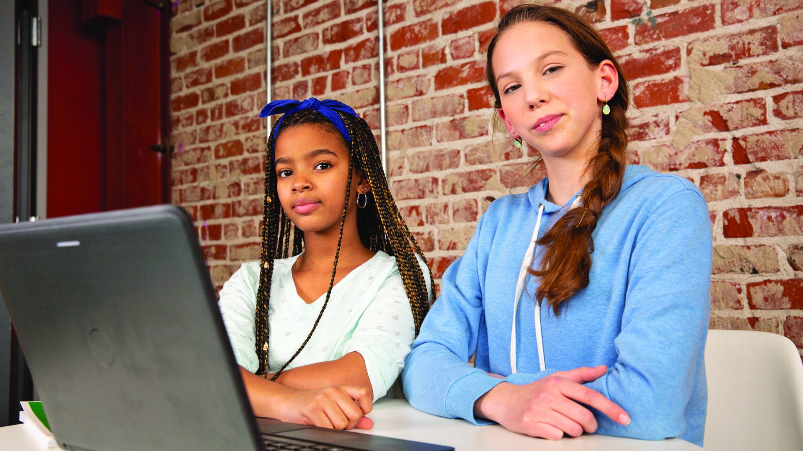 two girls looking at laptop