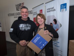 Man and woman holding laptop