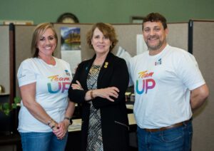 two women and one man wearing Project UP shirts