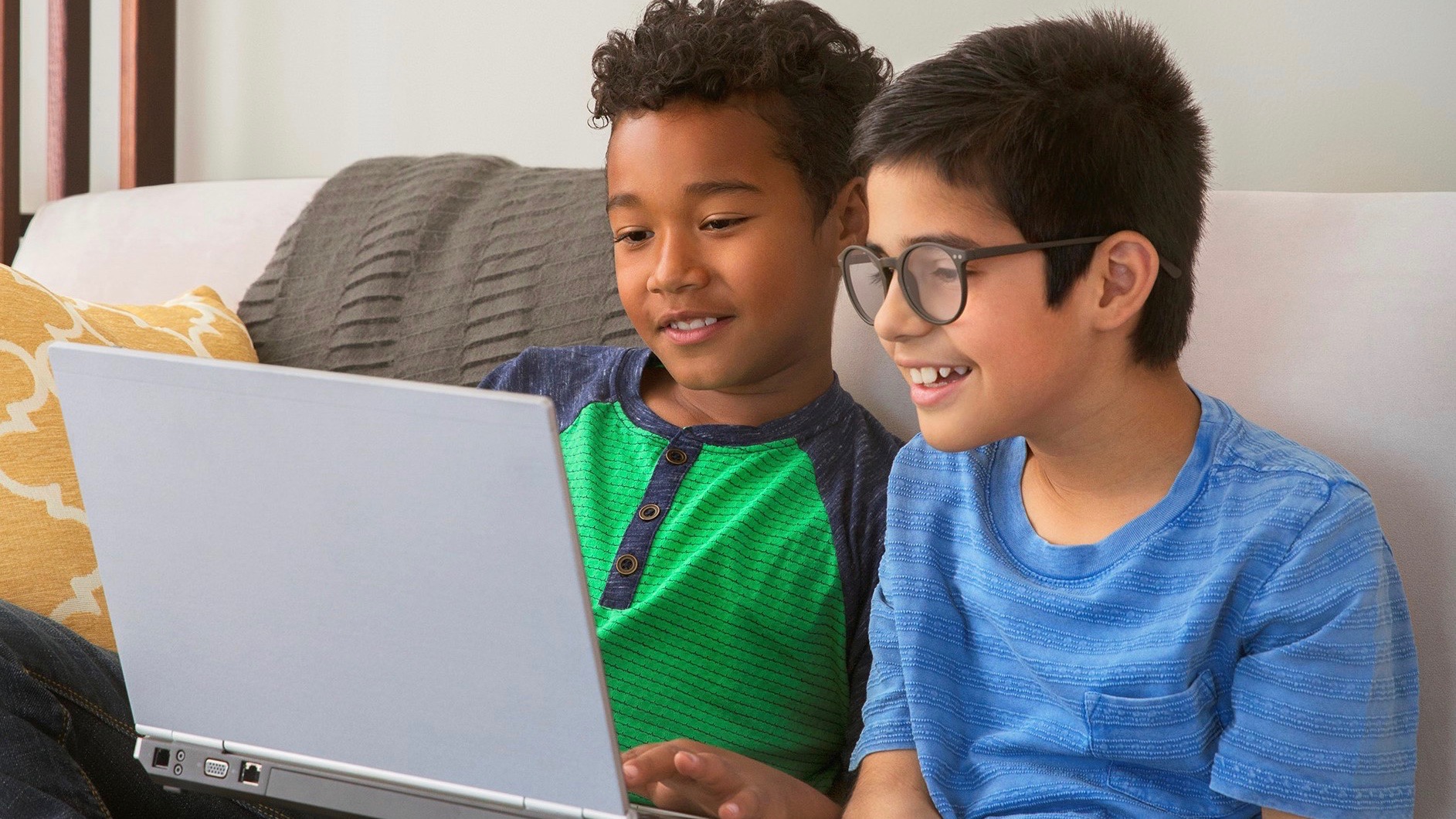 Two boys playing on a computer together